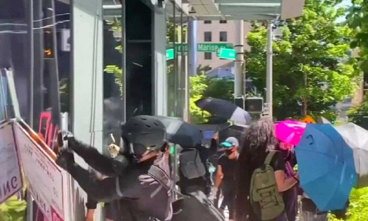 Rioters try to break into an Amazon store in Seattle in a July 19, 2020, file photograph. (Katie Daviscourt via Reuters)