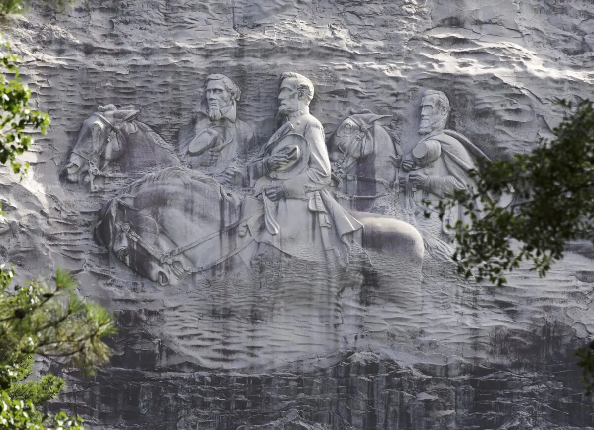 A protester holds a Black Lives Matter sign in front of the Confederate carving in Stone Mountain Park in Stone Mountain, Ga., on June 16, 2020. (Jessica McGowan/Getty Images)
