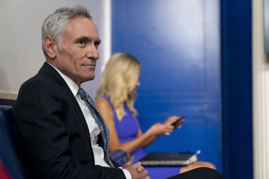 Scott Atlas (L), senior fellow at the Hoover Institution, and White House press secretary Kayleigh McEnany arrive ahead of President Donald Trump for a news conference at the White House in Washington, on Aug. 12, 2020. (Andrew Harnik/AP Photo, File)