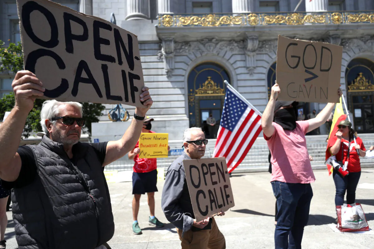 Demonstrators protest California Gov. Gavin Newsom's continued statewide shelter in place order outside of San Francisco City Hall on May 1, 2020. (Justin Sullivan/Getty Images)