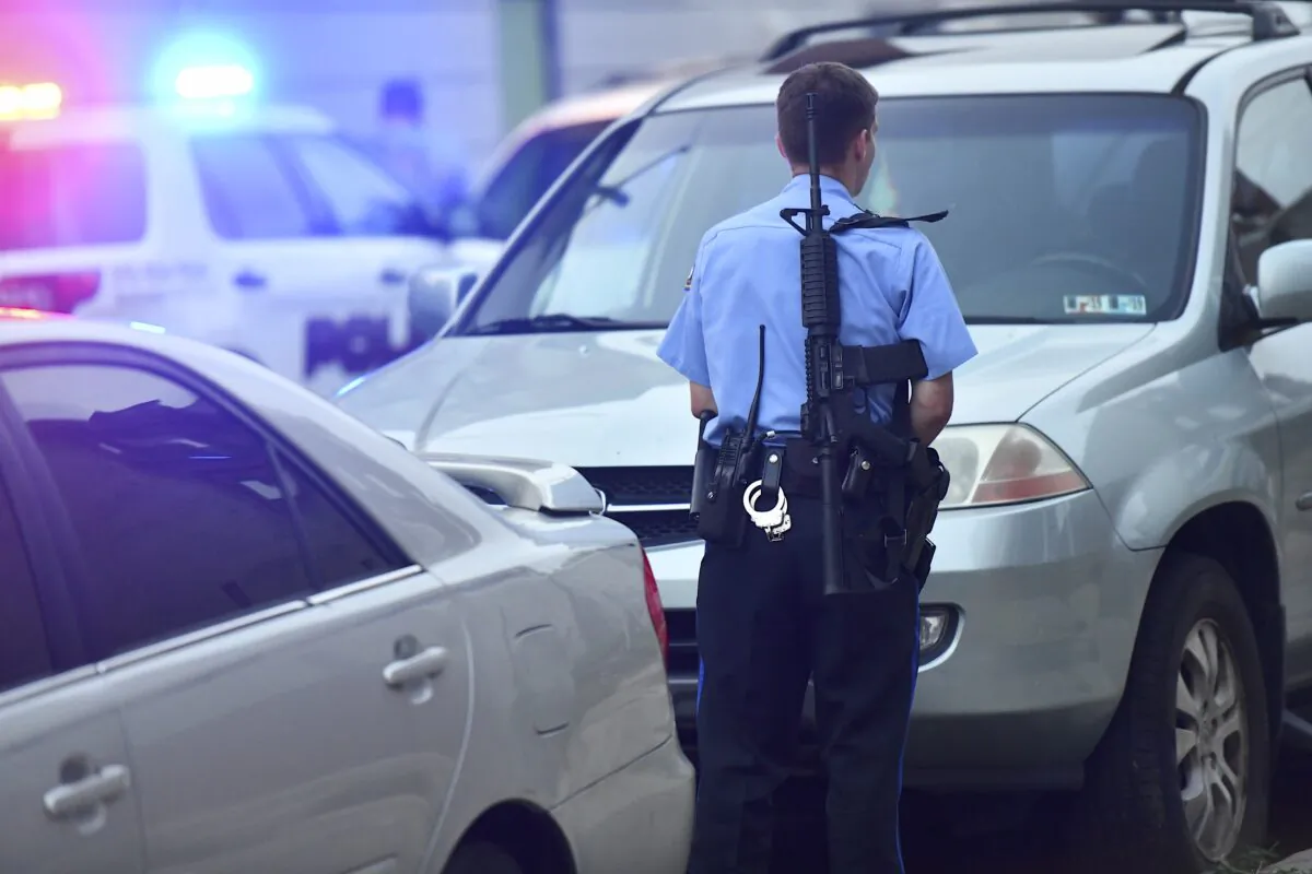 A police officer with a rifle monitors activity while responding to a shooting in Philadelphia, Pennsylvania, on Aug. 14, 2019. (Mark Makela/Getty Images)