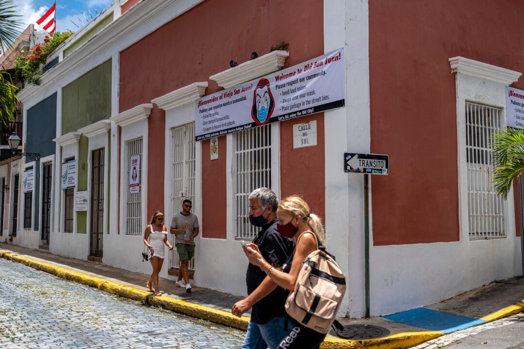 A building displays a banner urging visitors to wear face masks in San Juan, Puerto Rico, on July 20, 2020. (Ricardo Arduengo/AFP via Getty Images)