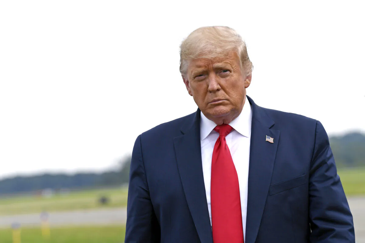 President Donald Trump walks over to speak with the press after arriving on Air Force One at Morristown Municipal Airport in Morristown, N.J., on Aug. 14, 2020. (Susan Walsh/AP Photo)