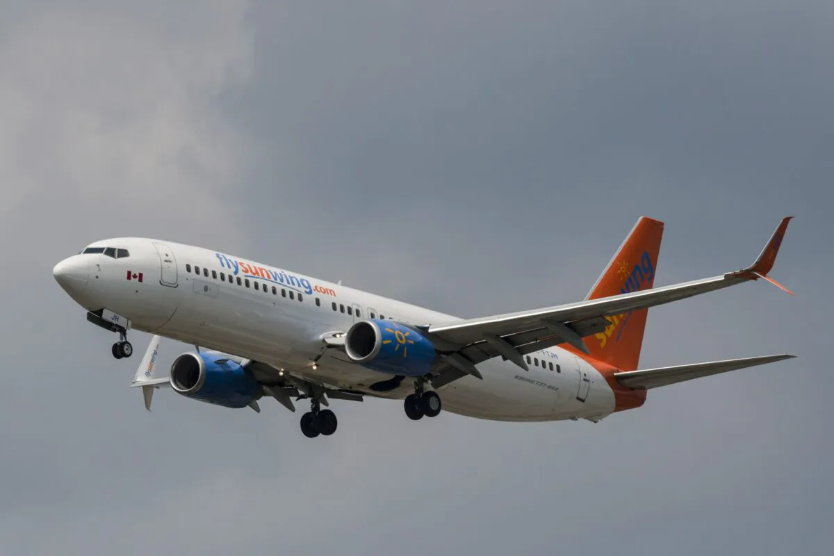 A Sunwing Airlines passenger plane prepares to land at Pearson International Airport in Toronto on Aug. 2, 2017. (The Canadian Press/Christopher Katsarov)