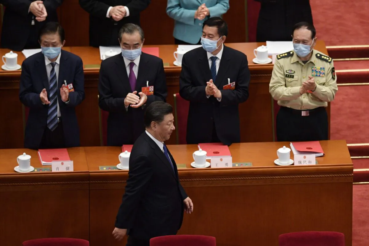 Chinese leader Xi Jinping is applauded by top officials as he arrives for the closing session of the regime’s rubber-stamp legislative conference at the Great Hall of the People in Beijing, China, on May 28, 2020. (Nicolas Asfouri/AFP via Getty Images)