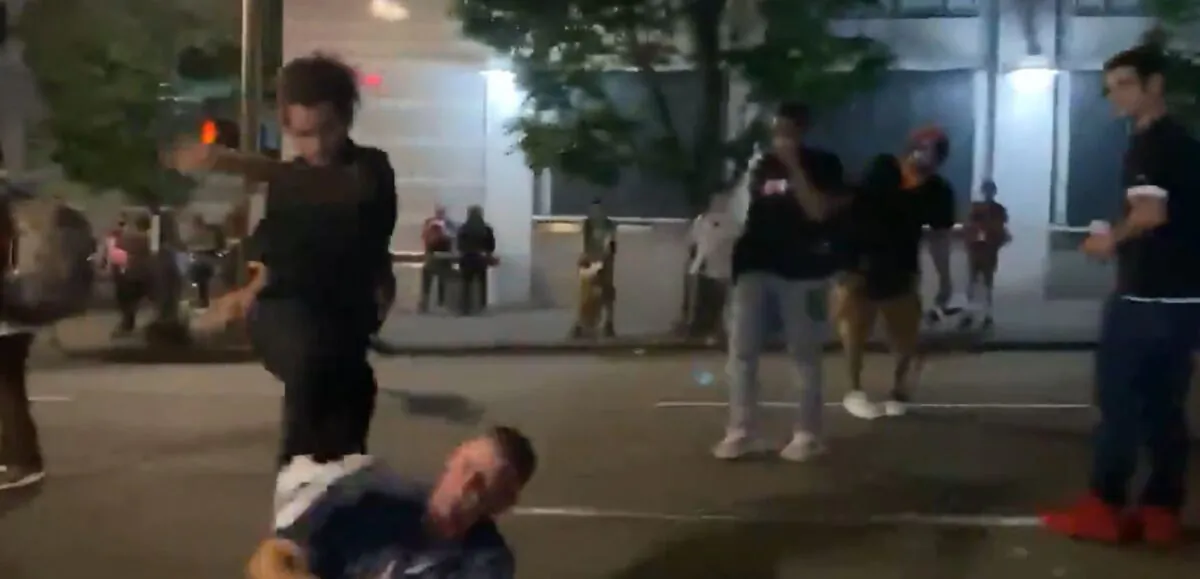 A man identified by police as Marquise Love, left, kicks Adam Haner in the face in Portland, Ore., on Aug. 16, 2020. (Kalen D’Almeida/Scriberr News)