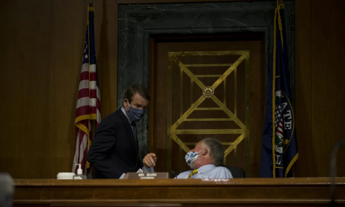 Sen. Michael Bennet (D-CO) speaks with Chairman Richard Burr (R-NC) before a Senate Intelligence Committee nomination hearing at the Dirksen Senate Office building on Capitol Hill on Capitol Hill on May 5, 2020 in Washington. (Gabriella Demczuk -Pool/Getty Images)