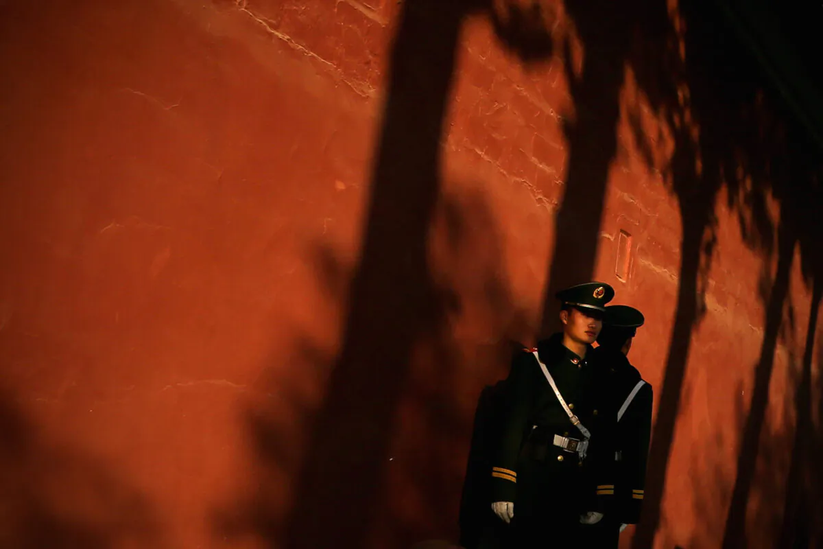 A paramilitary policeman guards outside the Great Hall of the People in Beijing on November 12, 2013. (Feng Li/Getty Images)