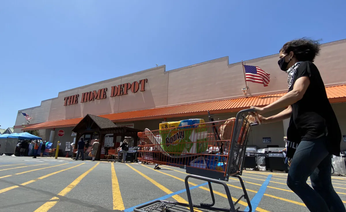 A shopper wearing a mask pushes her cart outside a Home Depot in Marina Del Rey, Calif., on May 22, 2020. (Chris Delmas/AFP/Getty Images)
