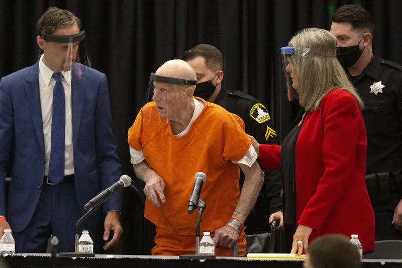 Joseph James DeAngelo, charged with being the Golden State Killer, is helped up by his attorney, Diane Howard, as Sacramento Superior Court Judge Michael Bowman enters the courtroom in Sacramento, Calif., on June 29, 2020. (Rich Pedroncelli/AP Photo)