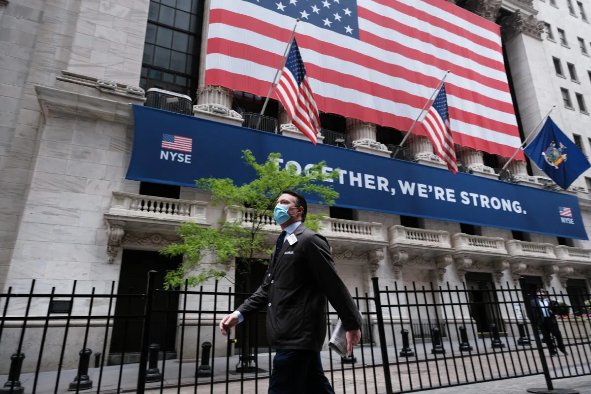 A trader walks by the New York Stock Exchange on May 26, 2020. (Spencer Platt/Getty Images)