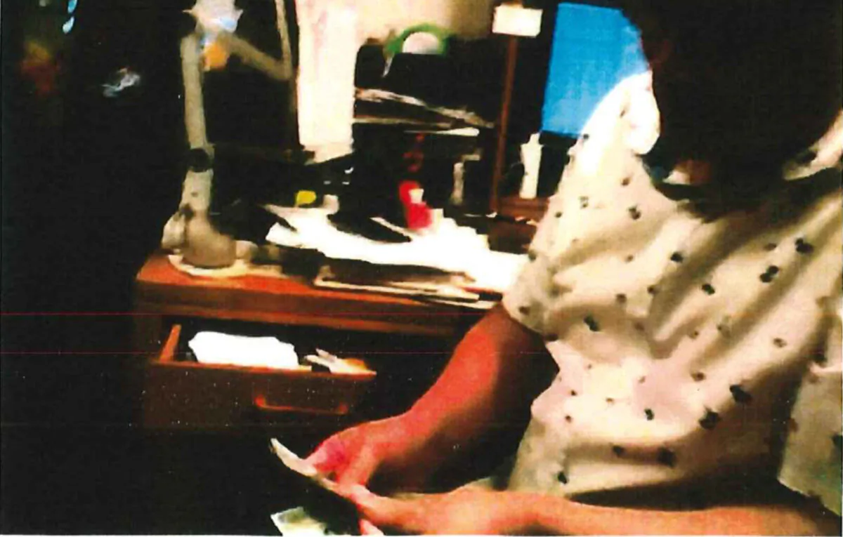 Alexander Ma counting cash given by an undercover FBI officer during a meeting in Aug. 2020. (FBI Affidavit)