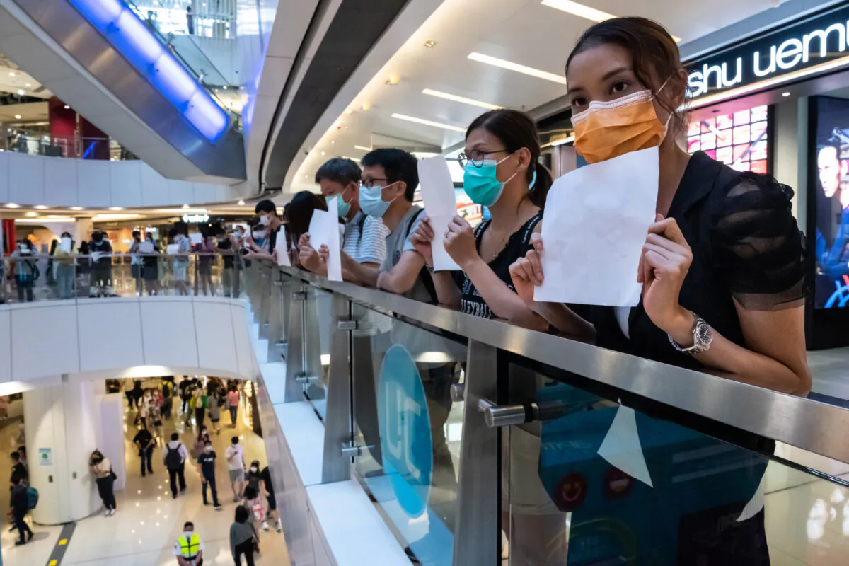 Protesters hold up blank papers during a demonstration in a mall in Hong Kong, on July 6, 2020. Hong Kongers are finding creative ways to voice dissent as police began making arrests for people displaying now forbidden political slogans. (Billy H.C. Kwok/Getty Images)