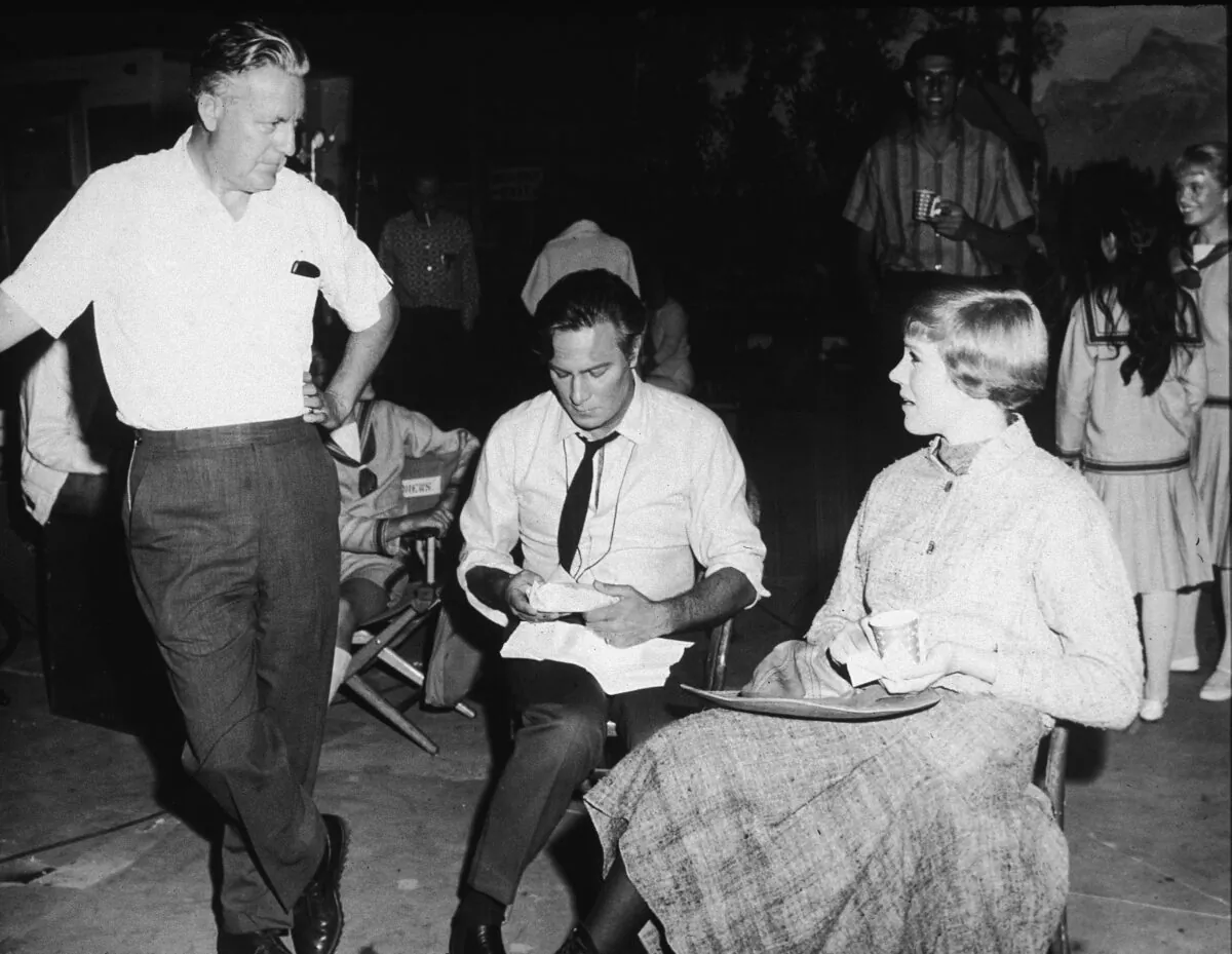 (L–R) Director Robert Wise, Canadian actor Christopher Plummer, and British actress Julie Andrews talk on the film set of “The Sound of Music,” 1965. (Photo by Hulton Archive/Getty Images)