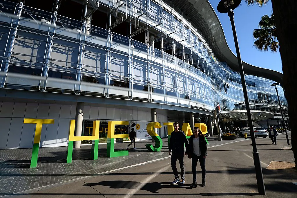 Tourists walk outside a casino complex in Darling Harbour in Sydney on July 2, 2014. (PETER PARKS/Getty Images)