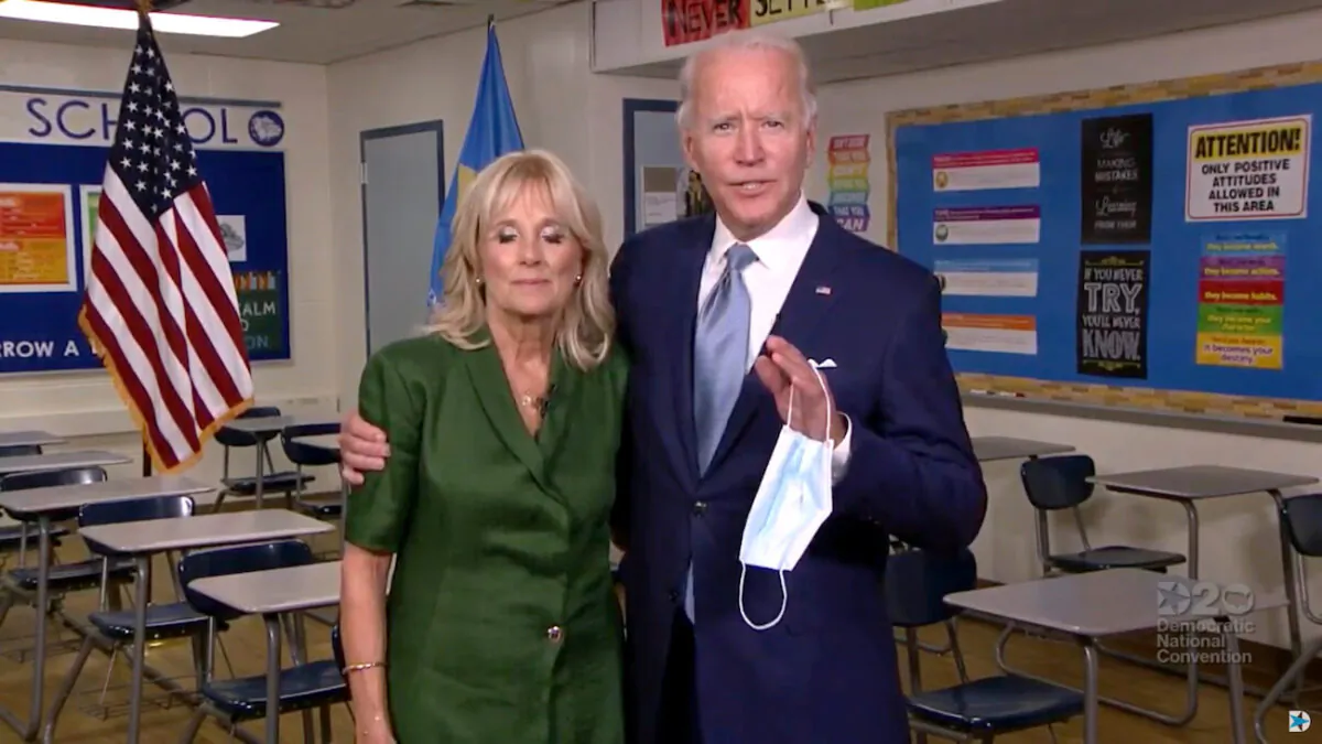 Democratic presidential candidate Joe Biden and his wife Jill Biden embrace as they speak from Brandywine High School, where she taught English from 1991 to 1993, during the virtual 2020 Democratic National Convention as participants from across the country are hosted over video links from the originally planned site of the convention in Milwaukee, Wisconsin, Aug. 18, 2020. (2020 Democratic National Convention/Pool via Reuters)