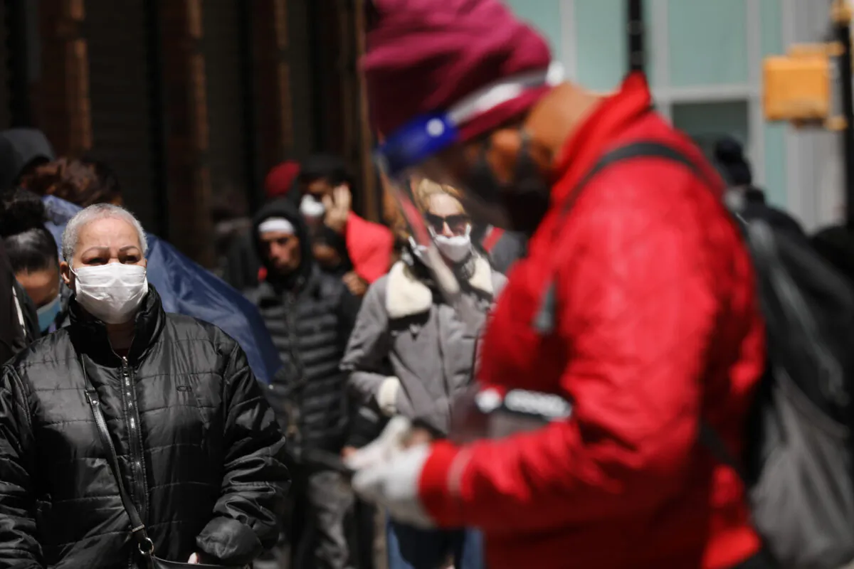 Hundreds of people wait in line for hours at a downtown Brooklyn office for their EBT Food Stamp cards in New York City on May 12, 2020. (Spencer Platt/Getty Images)