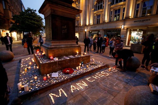 people attending a vigil for the victims of the Manchester Arena bombing, in central Manchester, Britain