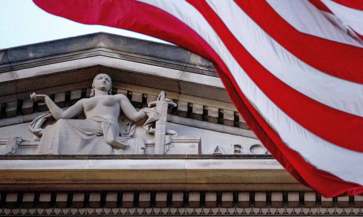 An American flag flies outside the Department of Justice in Washington on March 22, 2019. (Andrew Harnik/AP Photo)