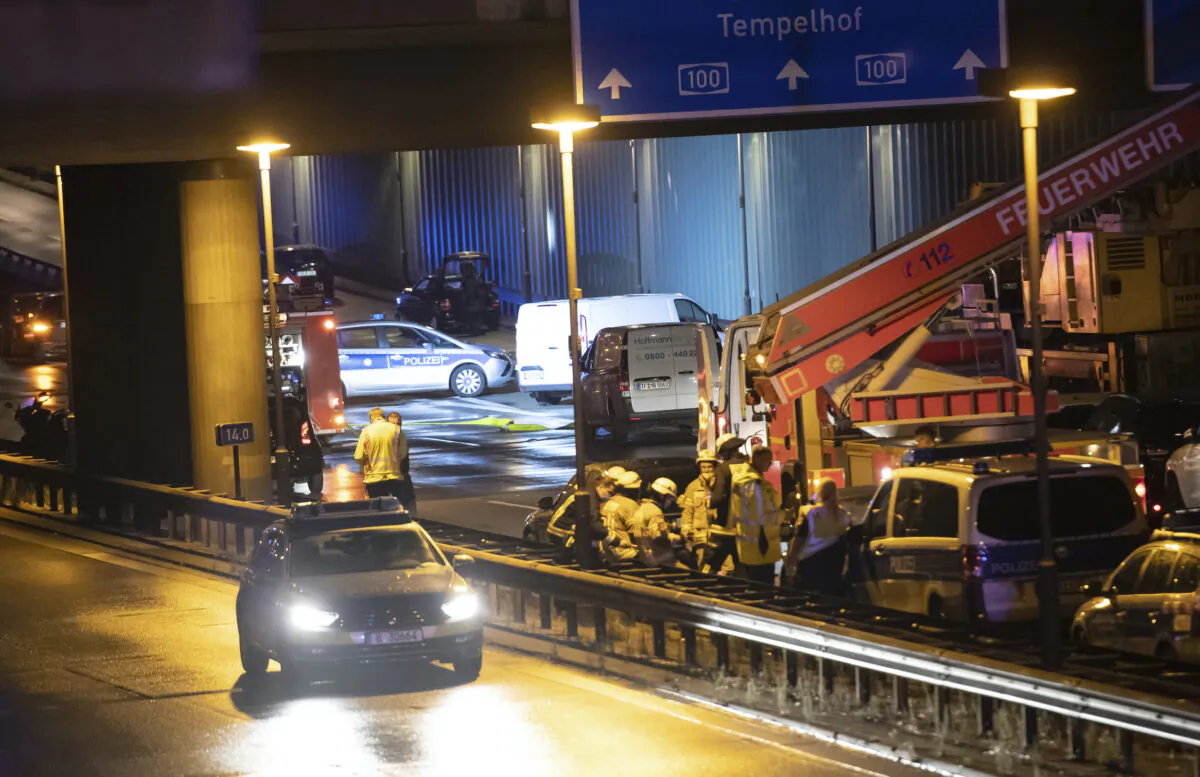 Forensic experts are investigating a car at the city motorway A100 after an accident in Berlin on Aug. 18, 2020. (Paul Zinken/dpa via AP Photo)