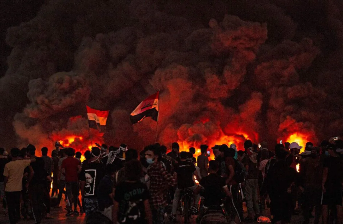 Iraqi demonstrators gather near burning tires during a protest near the governor's residence in the southern city of Basra, to protest assassinations and demand the resignation of top security officials, on Aug. 17, 2020. (Hussein Faleh/AFP via Getty Images)