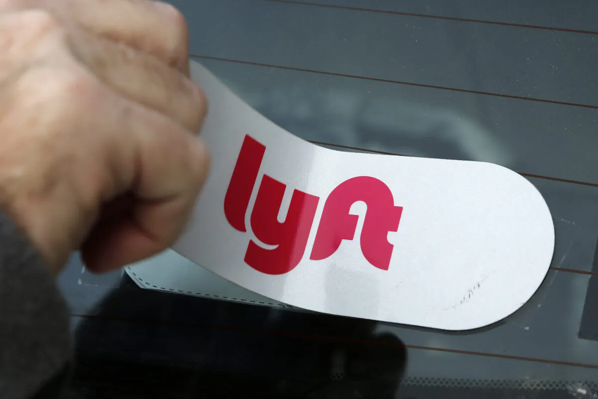 A Lyft logo is applied to a car in a file image. (Gene J. Puskar/AP Photo)