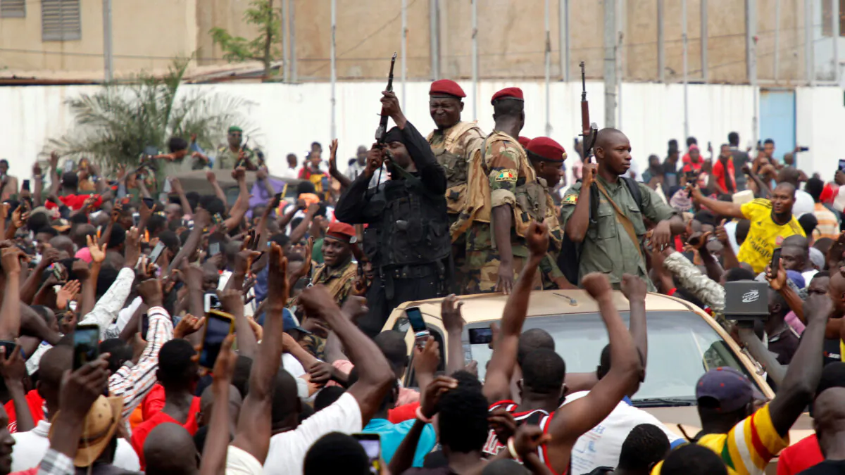 A crowd of people cheer Malian army soldiers at the Independence Square after a mutiny, in Bamako, Mali on Aug. 18, 2020. (Moussa Kalapo/Reuters)