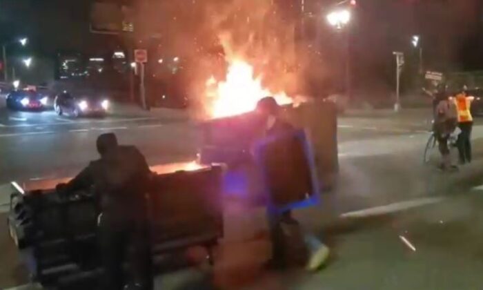 Rioters push flaming dumpsters in Portland, Ore., on Aug. 19, 2020. (Reuters)