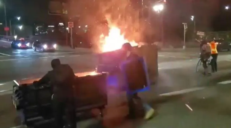 Rioters push flaming dumpsters in Portland, Ore., on Aug. 19, 2020. (Reuters)