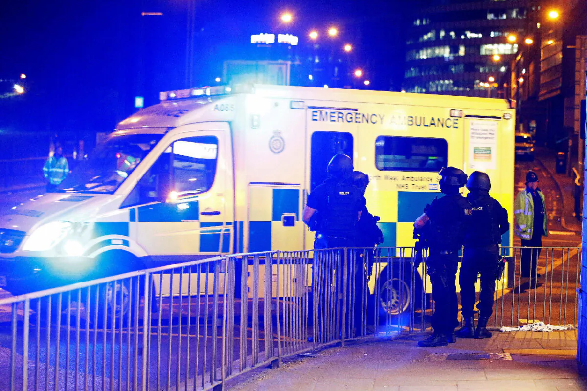 File photo shows armed police officers standing near the Manchester Arena, in Manchester, England, on 23, 2017. (Andrew Yates/Reuters)
