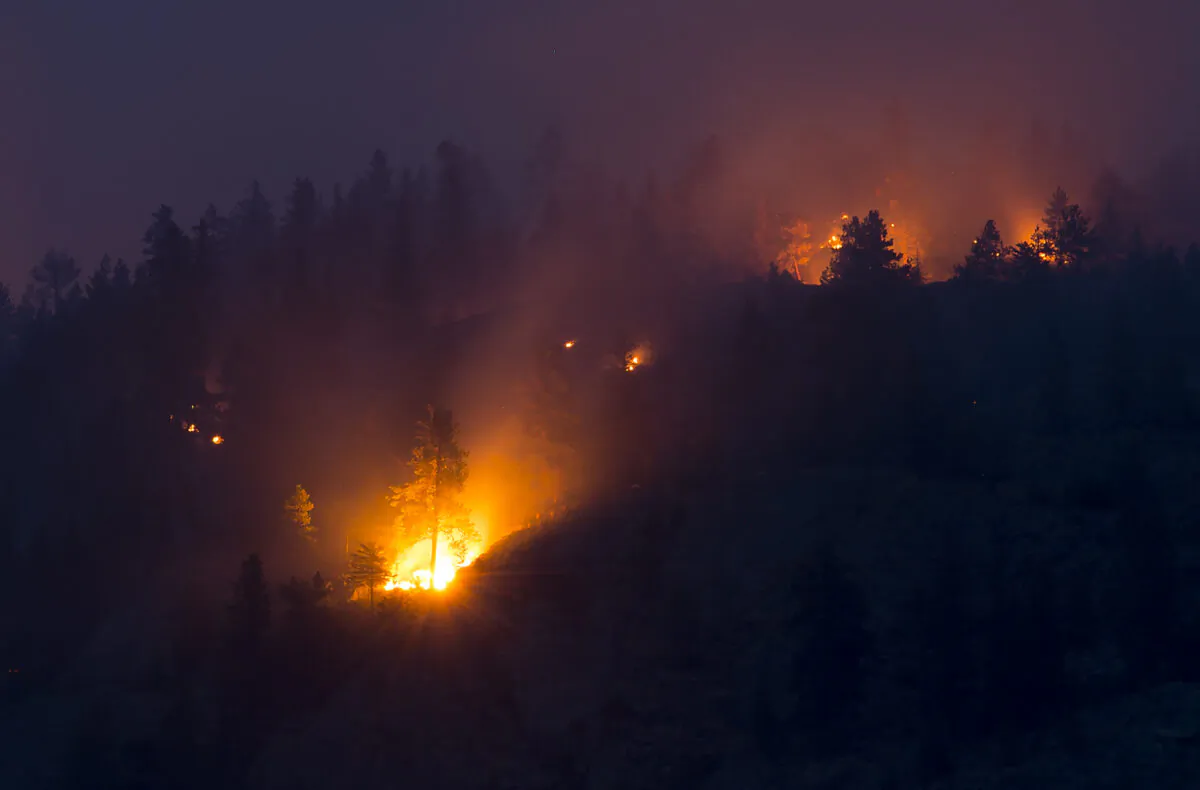 Flareups are seen from the Christie Mountain wildfire along Skaha Lake in Penticton, B.C. Thursday, August 20, 2020.  (The Canadian Press/Jonathan Hayward)