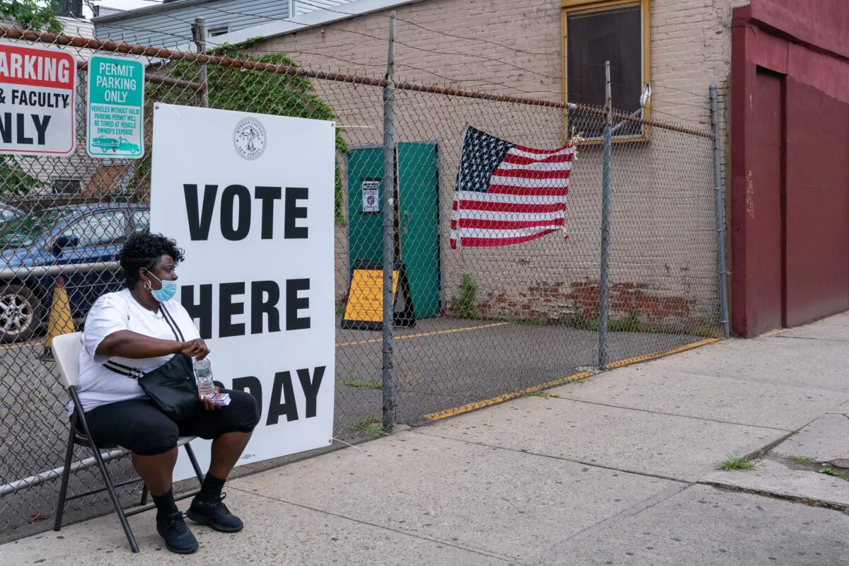 A poll worker sits outside of the polling station in Saint Aloysius in Jersey City, N.J., on July 7, 2020. (David Dee Delgado/Getty Images)