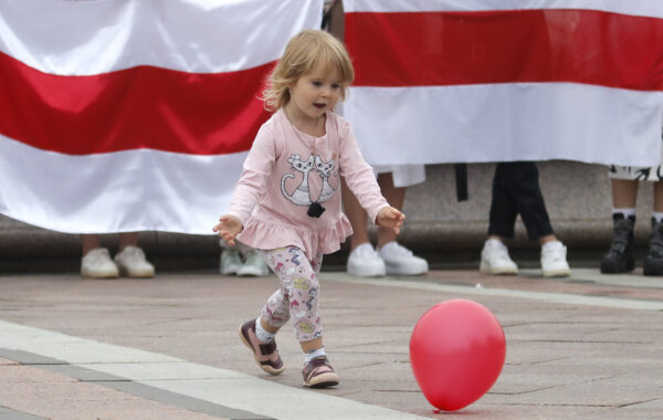 A girl plays with a balloon during a protest in Minsk