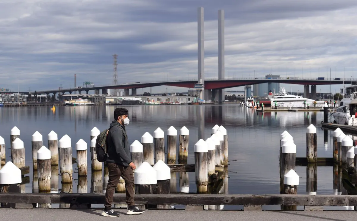 A man wearing a face mask walks in Melbourne's Docklands district on Aug. 14, 2020. (William West/AFP via Getty Images)