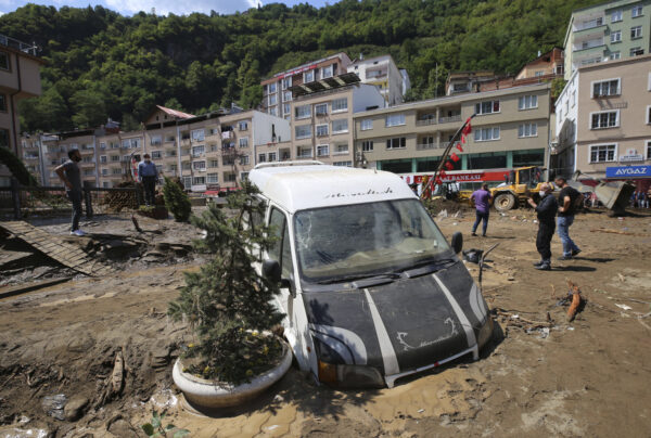 People inspect the destruction after floods