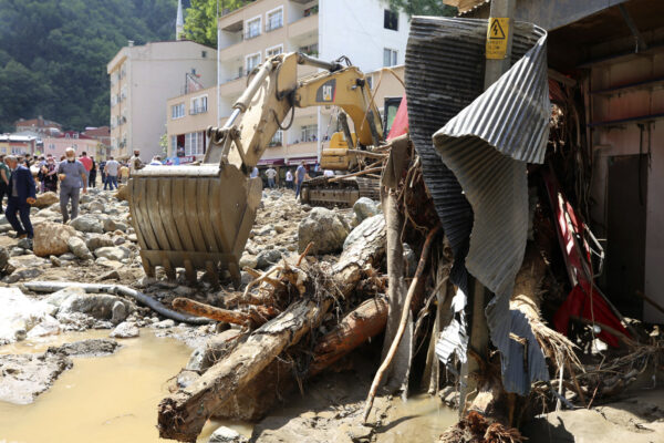 People inspect the destruction after floods
