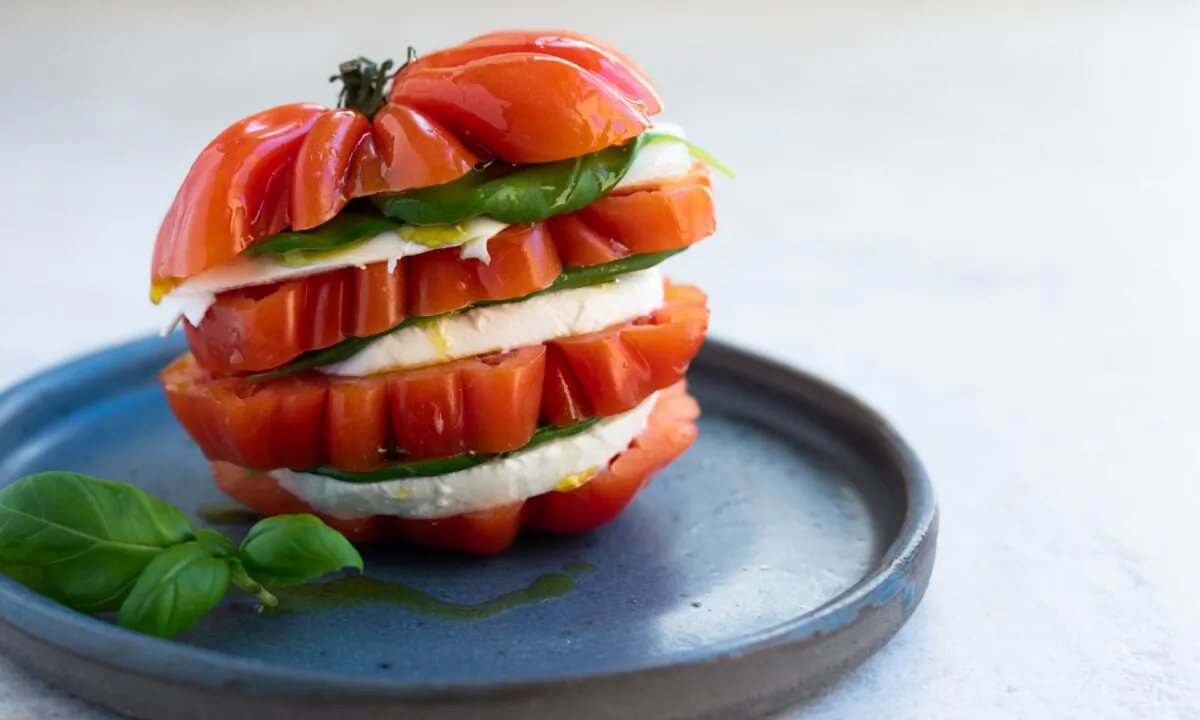 Summer tomatoes meet fresh mozzarella and basil in caprese, a classic Italian salad. (Delphine Remy/Shutterstock)