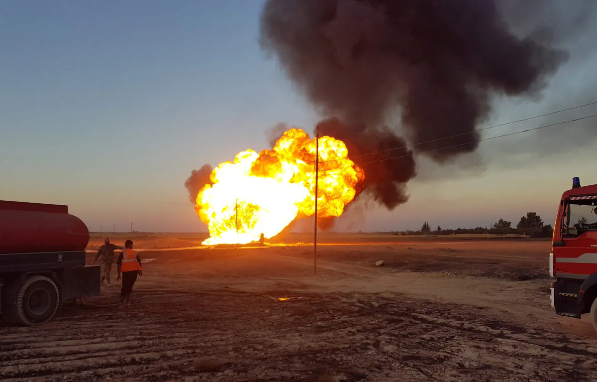 Fire and plumes of smoke are seen from an explosion on the Arab Gas Pipeline between the towns of Ad Dumayr and Adra, northwest of the capital of Damascus, Syria, on Aug. 24, 2020. (Sana/Handout via Reuters)