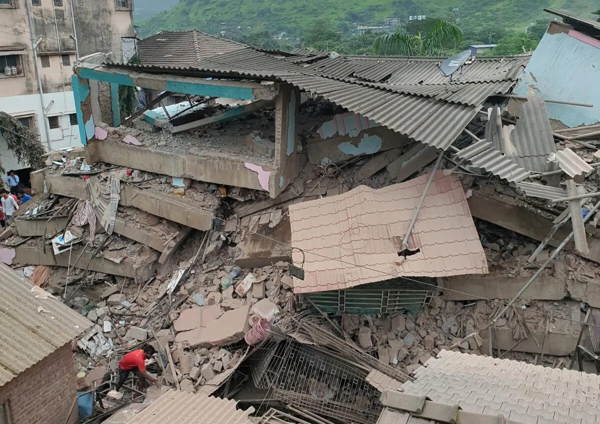 A man removes the debris after a five-storey building collapsed in Raigad in the western state of Maharashtra, India, on Aug. 24, 2020. (Stringer/Reuters)