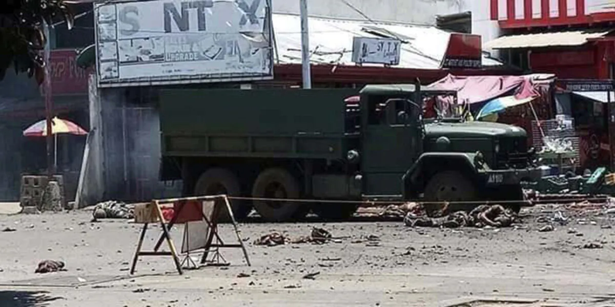 A military truck lies at an area where a bomb exploded at the town of Jolo, Sulu province, southern Philippines, on Aug. 24, 2020. (Philippine National Red Cross via AP)