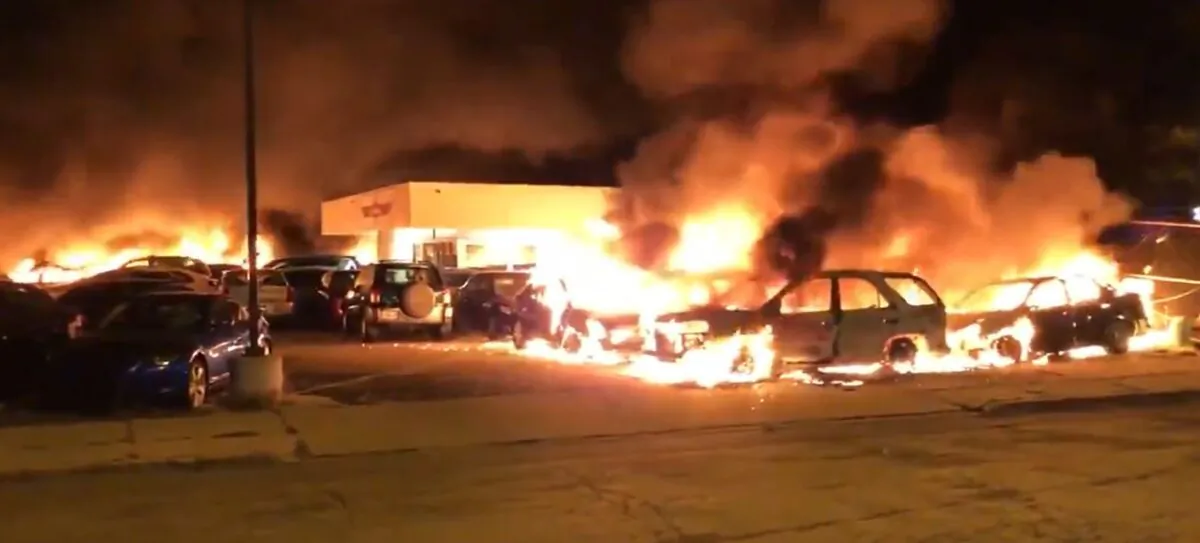 A car dealership burns after being set on fire amid rioting in Kenosha, Wis., early Aug. 24, 2020. (Drew Hernandez/@livesmattershow)