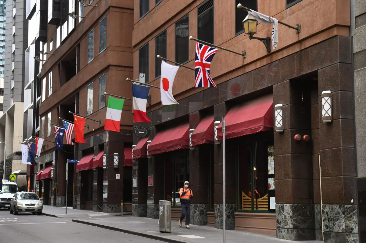 A man walks past the Stamford Plaza Hotel, used as an isolation hotel from returned travellers from overseas as part of measures against COVID-19, in Melbourne on July 22, 2020. (William West/AFP via Getty Images)