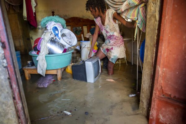 Lafaille Katia removes salvage items from her flooded house