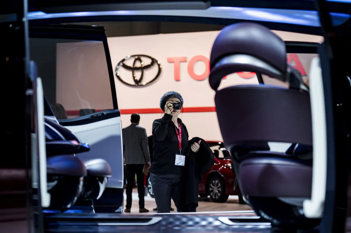 A woman photographs the interior of the Toyota concept car Fine-Comfort Ride at the Canadian International Auto Show in Toronto on Thursday, February 14, 2019. (Christopher Katsarov/The Canadian Press)