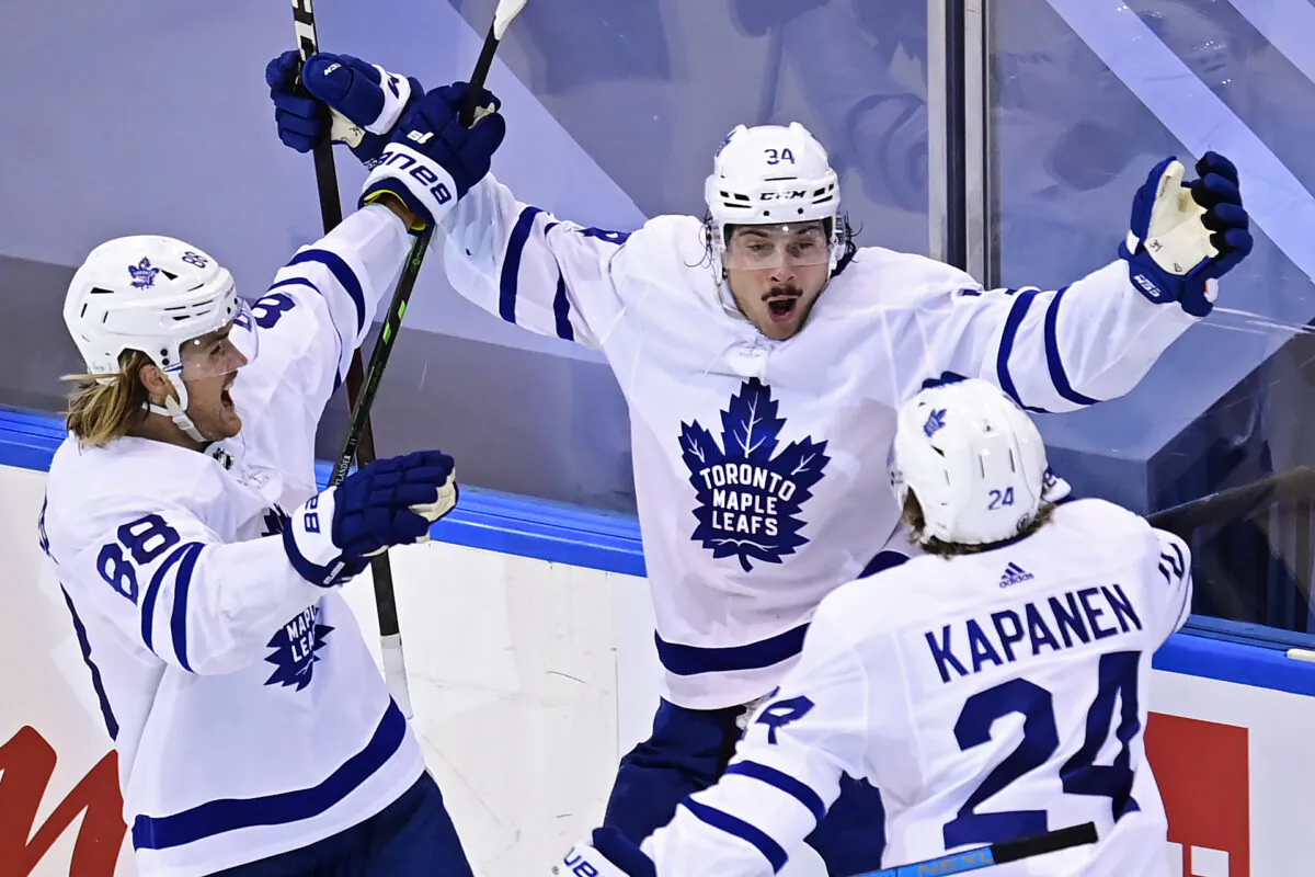Toronto Maple Leafs' Auston Matthews (34) celebrates his game winning goal against the Columbus Blue Jackets' with teammates William Nylander (88) and Kasperi Kapanen (24) during overtime NHL Eastern Conference Stanley Cup playoff action in Toronto on Friday, August 7, 2020. THE CANADIAN PRESS/Frank Gunn