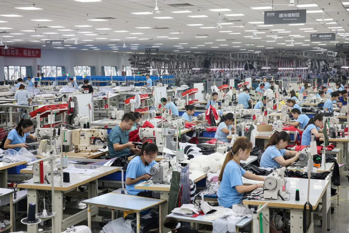 Employees produce down coats at a factory for Chinese clothing company Bosideng in Nantong in China's eastern Jiangsu Province on Sept. 24, 2019. (STR/AFP via Getty Images)