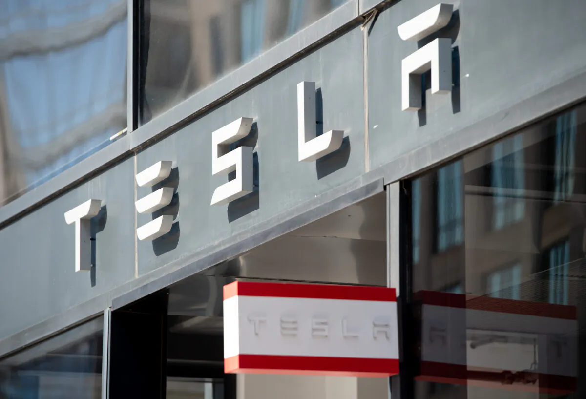 The Tesla logo is seen outside of their showroom in Washington on Aug. 8, 2018. (Saul Loeb/AFP via Getty Images)