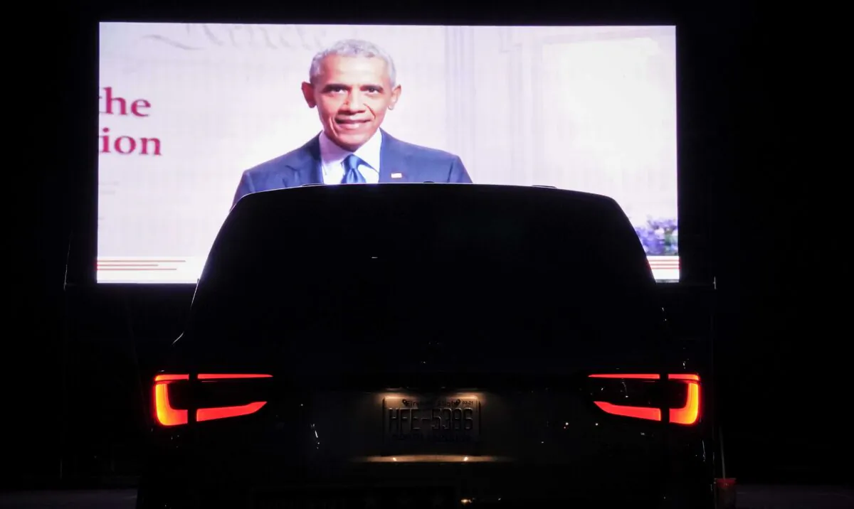Former President Barack Obama is displayed on a screen as members of the District of Columbia Democratic Party attend a drive-in watch party in the parking lot of the Robert F. Kennedy Memorial Stadium to watch Democratic presidential nominee former Vice President Joe Biden accept the Democratic nomination for president on the final night of the Democratic National Convention in Washington on Aug. 20, 2020. (Drew Angerer/Getty Images)