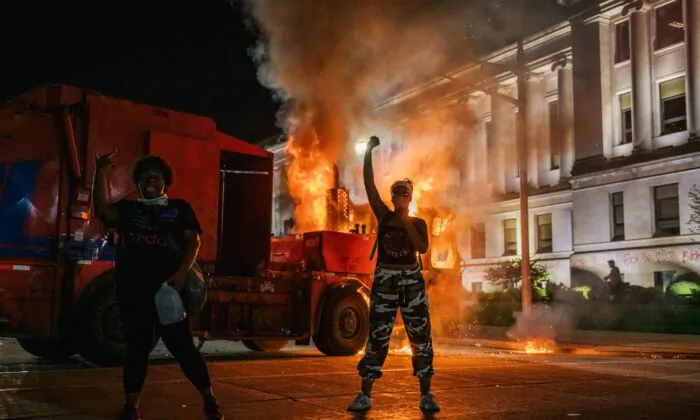 Rioters chant in front of a burning truck in Kenosha, Wis., on Aug. 24, 2020. (Brandon Bell/Getty Images)