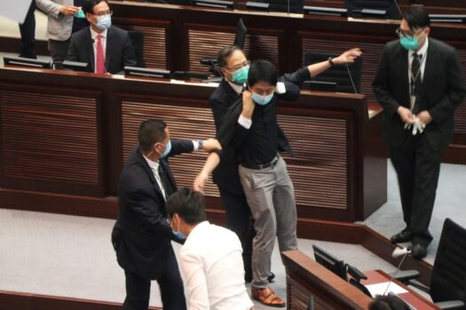 Security officers hold pro-democracy lawmaker Ted Hui